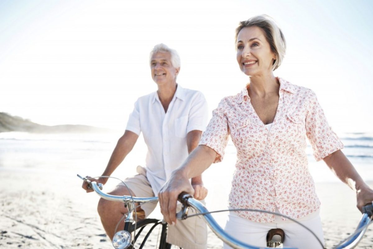 retired couple happy on the beach