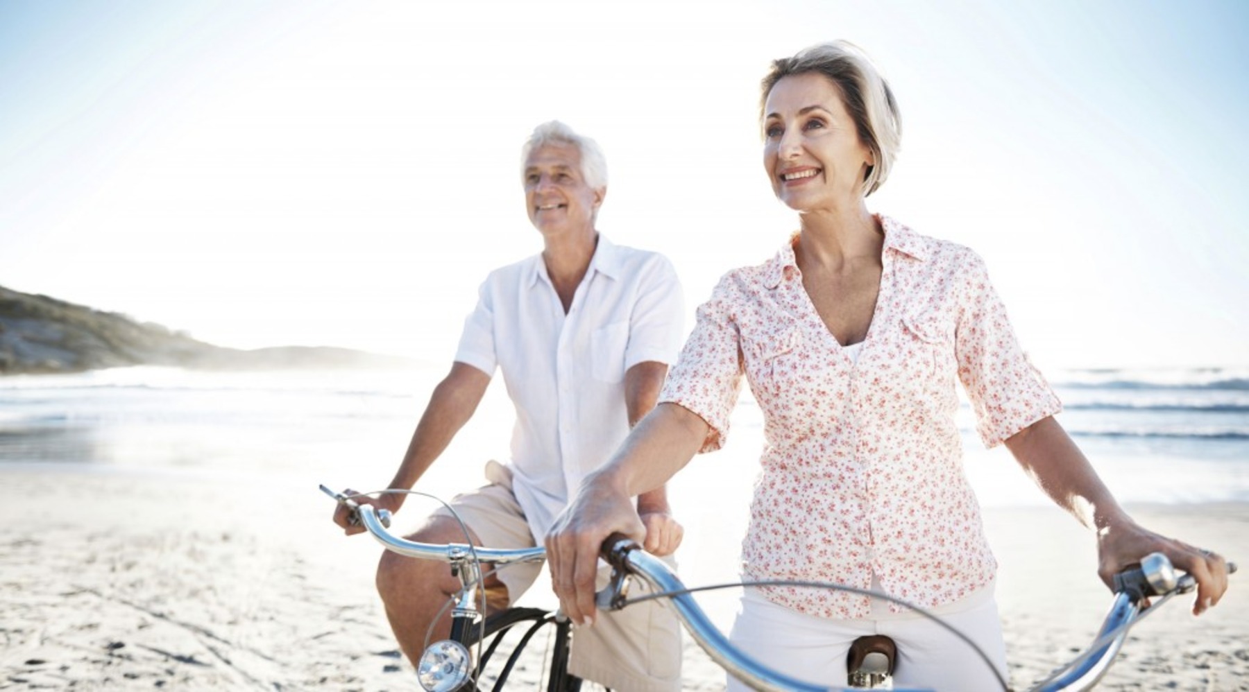retired couple happy on the beach